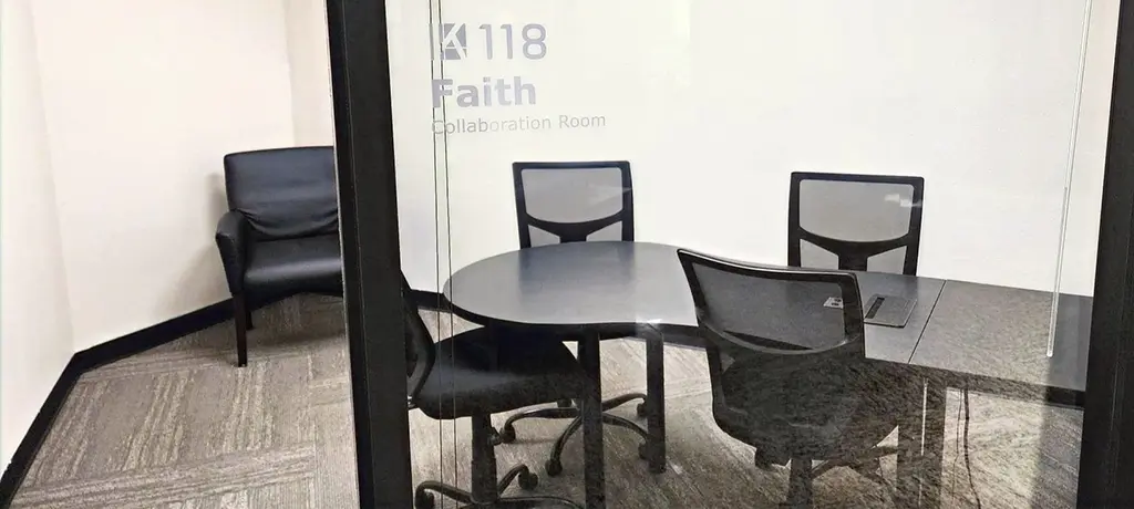 Faith collaboration room with conference table and chairs for coaching sessions at Kinected Coworking San Antonio