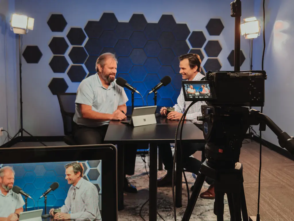 Two podcast hosts recording an episode in the Media Studio in San Antonio