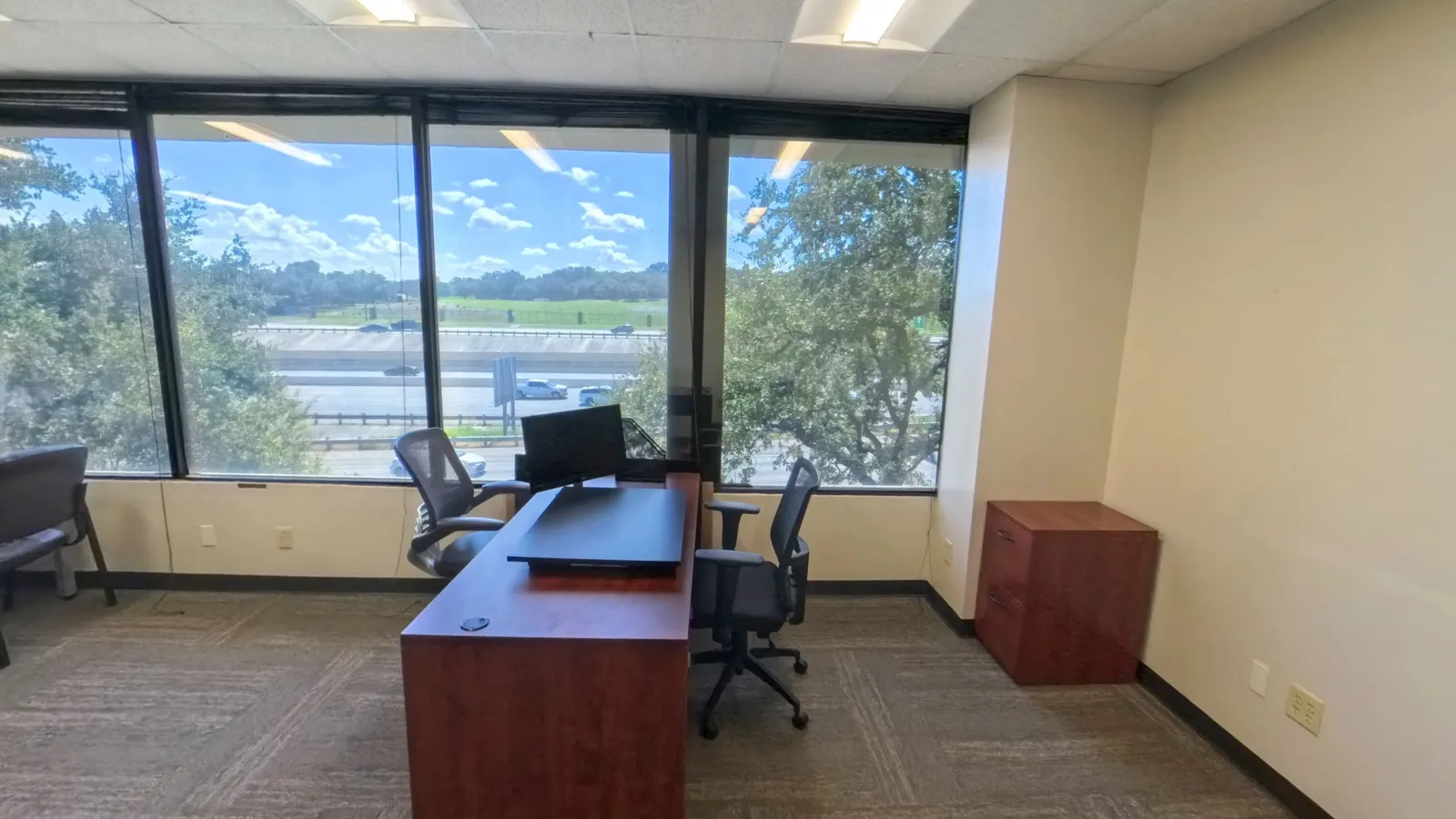Room 217 corner private office at Kinected Coworking with desk and wraparound windows