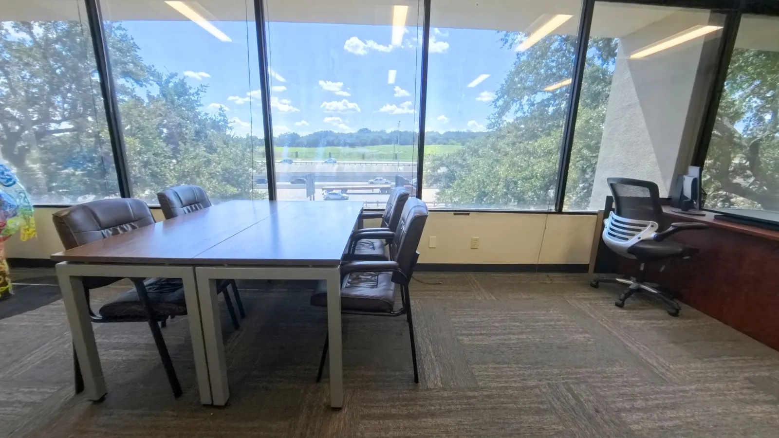 Room 217 with space for a meeting table beside the corner windows